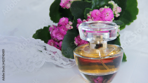 perfume or eau de toilette on a white background with flowers