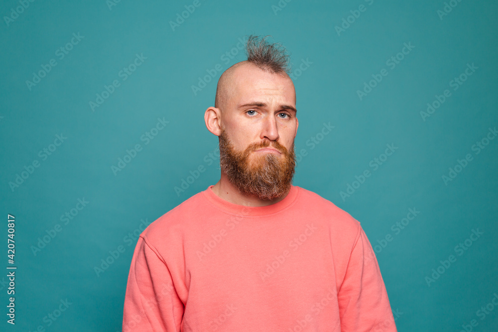 Bearded european man in casual peach isolated on turquoise background with gloomy expression needs support and help Bearded european man in casual peach isolated on turquoise background with gloomy expression needs support and help