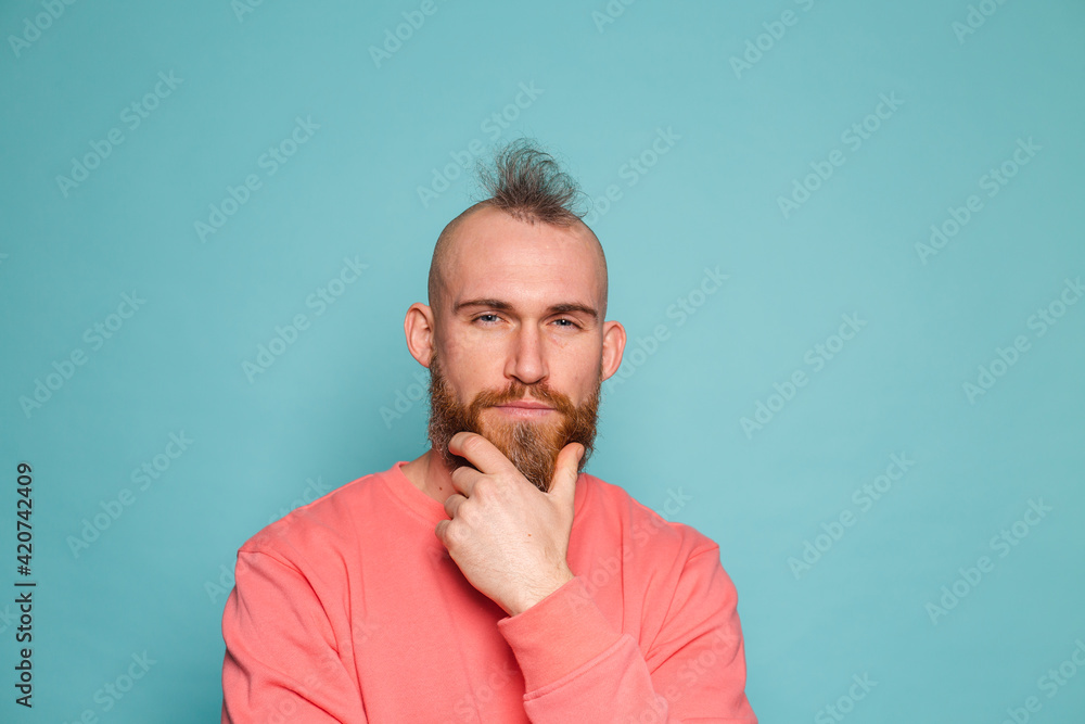 Bearded european man in casual peach isolated on turquoise background thinking worried about a question, concerned and nervous Bearded european man in casual peach isolated on turquoise background thinking worried about a question, concerned and nervous