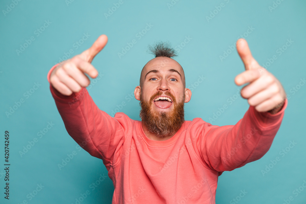 Bearded european man in casual peach isolated on turquoise background pointing to you and the camera with fingers, smiling positive and cheerful Bearded european man in casual peach isolated on turquoise background pointing to you and the camera with fingers, smiling positive and cheerful