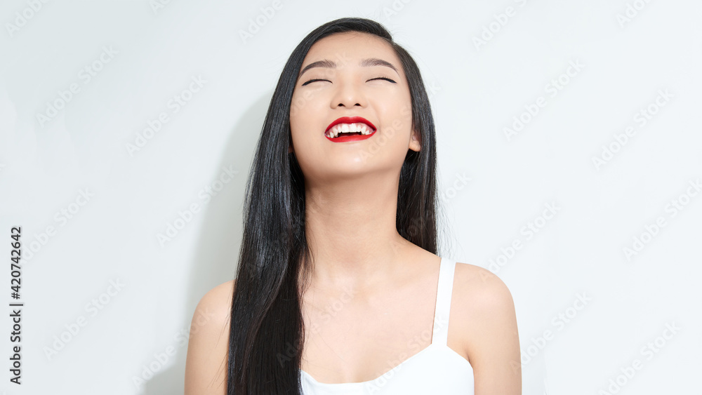 A happy laughing young woman with perfect skin, natural make-up and a beautiful smile. A happy laughing young woman with perfect skin, natural make-up and a beautiful smile.