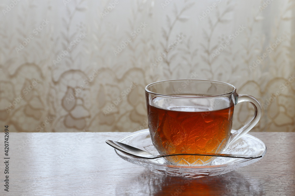 Tea in a transparent cup on a saucer. Tea in a transparent cup on a saucer.