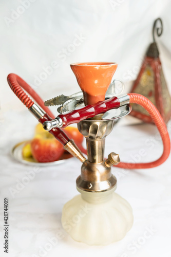 Glass arabian smoking hookah shisha  with apple flavor on a white background