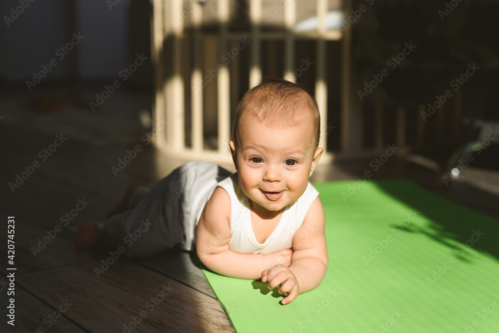 A small child plays on a sports mat alone A small child plays on a sports mat alone