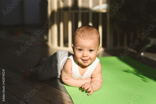 A small child plays on a sports mat alone