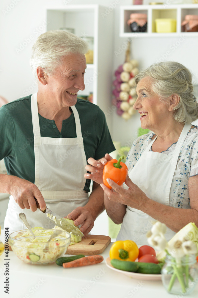 Senior couple cooking together at kitchen