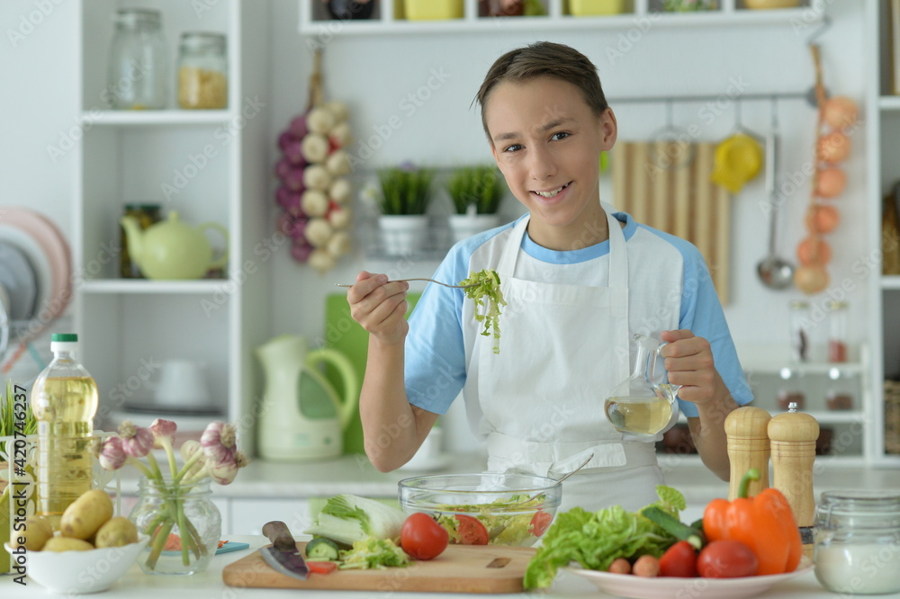 Cute boy preparing  cooking  at home