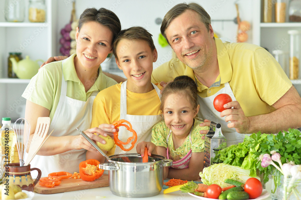 Cute family cooking together in kitchen Cute family cooking together in kitchen