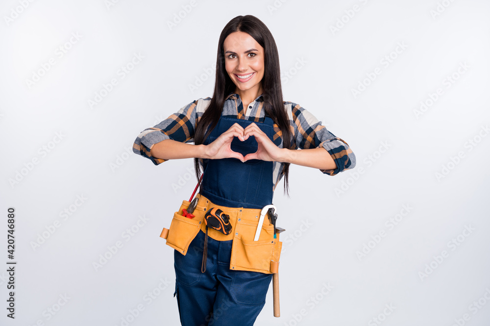 Photo of happy smiling cheerful good mood woman builder show heart shape sign isolated on white color background Photo of happy smiling cheerful good mood woman builder show heart shape sign isolated on white color background