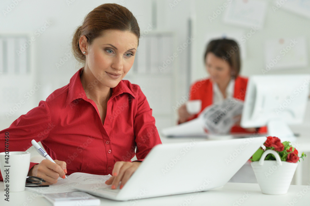Businesswoman architect working in modern office with her colleague Businesswoman architect working in modern office with her colleague