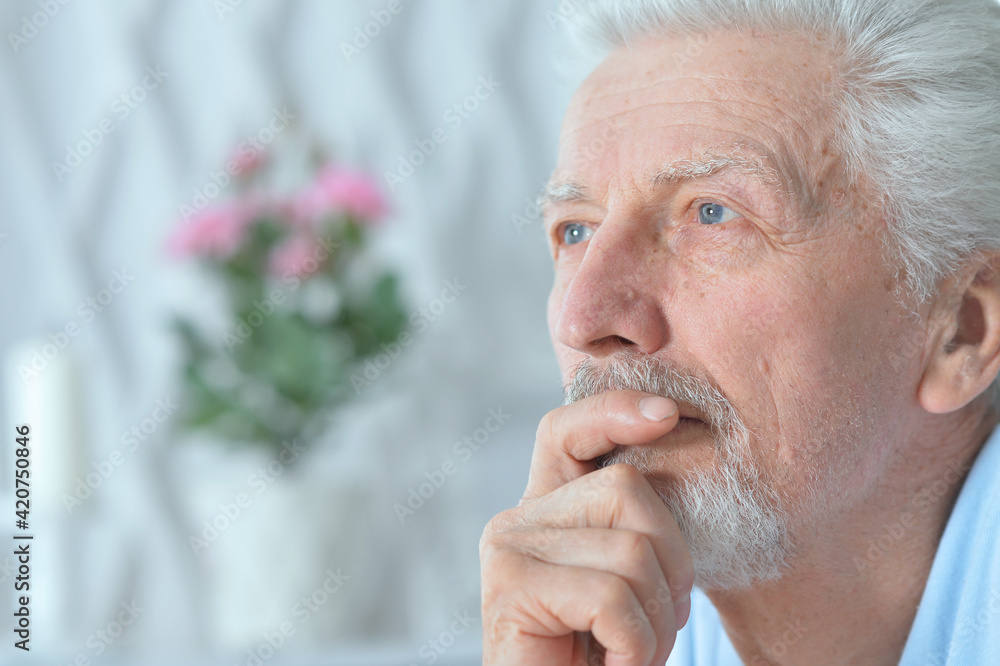 Close up portrait of thoughtful senior man at home Close up portrait of thoughtful senior man at home