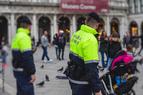 Fototapeta Naklejka Na Ścianę i Meble -  Italian police squad patrol formation back view with 
