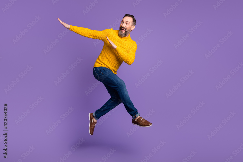 Full body profile portrait of energetic man look empty space arms dabbing isolated on purple color background