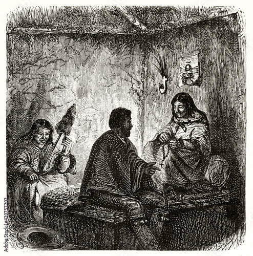 Catholic priest telling Gospel to south american indigenous holding rosary indoor in a hut. Ancient grey tone etching style art by Riou, Le Tour du Monde, 1862