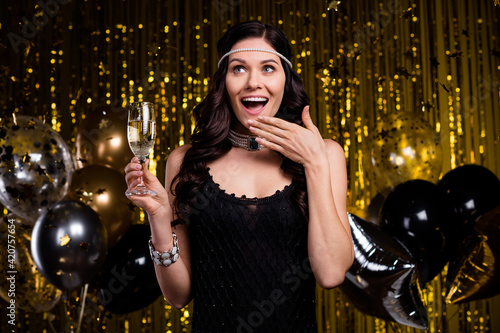 Portrait of astonished stunning lady arm near open mouth look interested empty space isolated on shiny curtain background