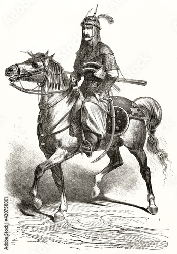 Kurdish knight on horse abreast equipped with light armor  helm and saber inside scabbard. Single full body figure. Grey tone etching style art by Duhousset  Le Tour du Monde  1862