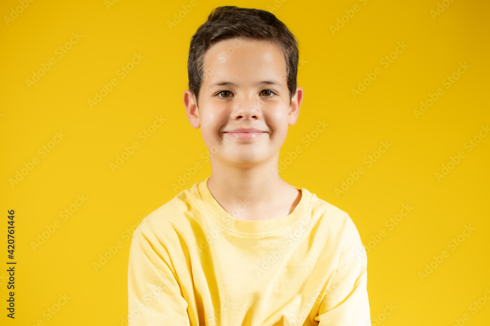 Portrait of happy boy smiling over yellow background Portrait of happy boy smiling over yellow background