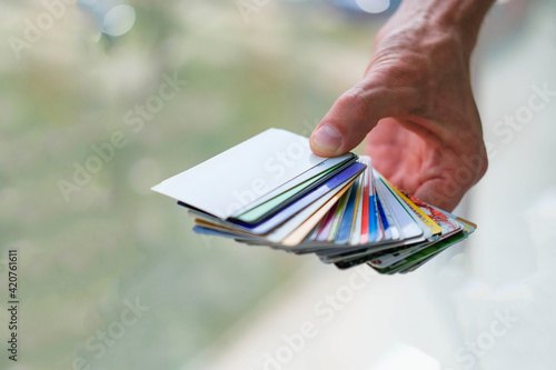 A man is hand holds a stack of discount cards. Discount card . photo