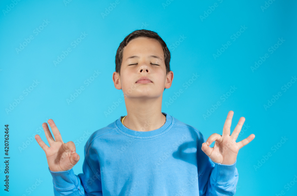 Pensive child with green sweater isolated on green background Pensive child with green sweater isolated on green background