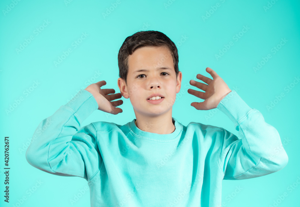 Portrait of beautiful emotional little boy on green background Portrait of beautiful emotional little boy on green background