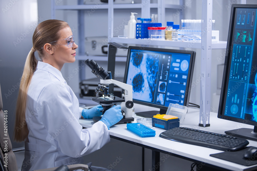 Professional female scientist is working on a vaccine in a scientific research laboratory. Genetic engineer workplace. Technology and science concept. Professional female scientist is working on a vaccine in a scientific research laboratory. Genetic engineer workplace. Technology and science concept.