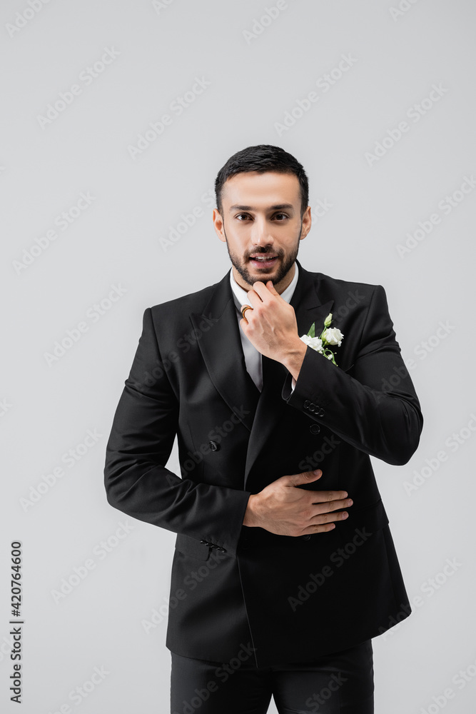 Smiling arabian groom looking at camera isolated on grey Smiling arabian groom looking at camera isolated on grey
