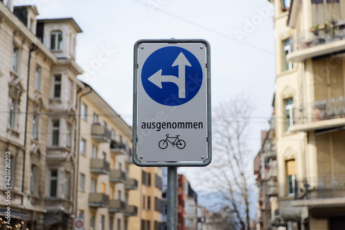 traffic sign, german text translation: prescribed direction of travel, straight ahead and left, except bicycles
