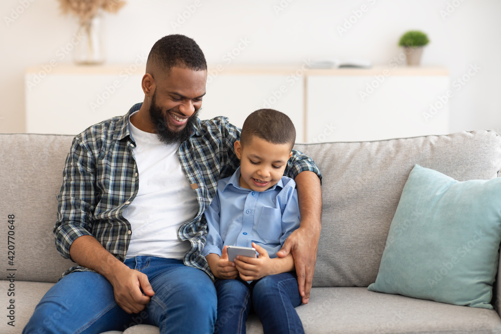Black Boy And Dad Using Phone Playing Games Online Indoor