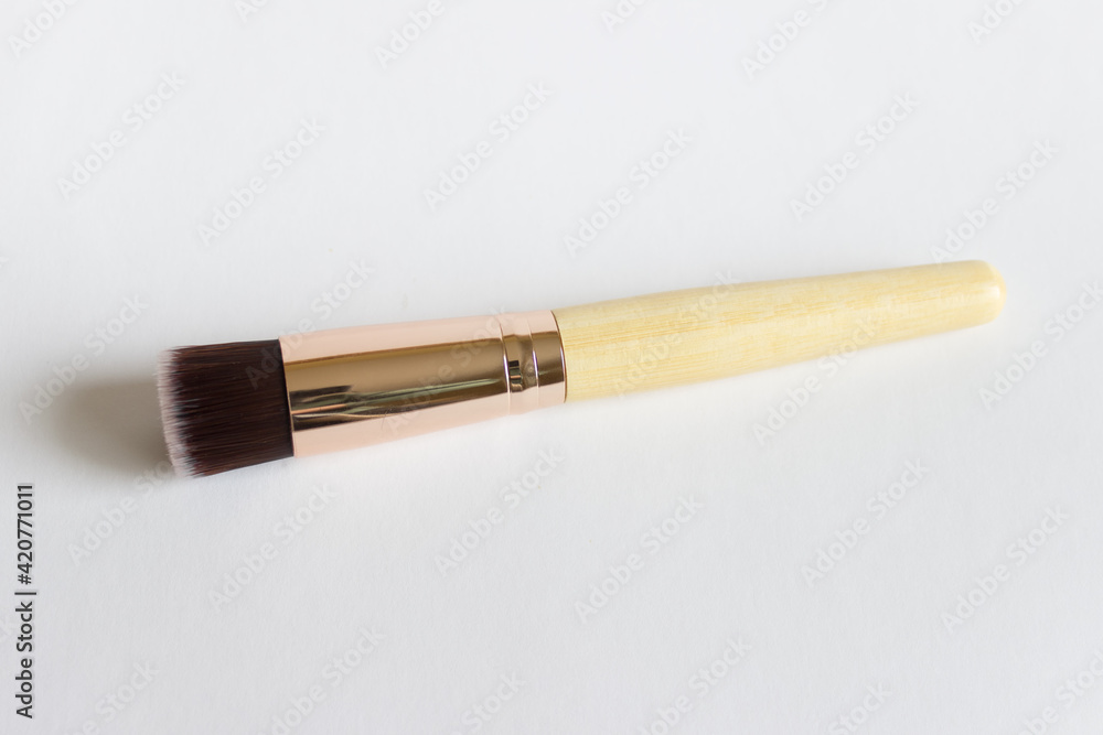 Mockup template of one single cosmetic brush with wooden handle and natural short bristles on white background. Mockup template of one single cosmetic brush with wooden handle and natural short bristles on white background.
