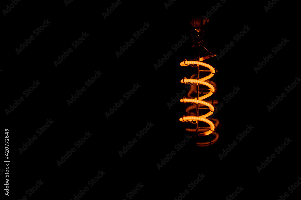 An orange bulb glowing in the dark An orange bulb glowing in the dark