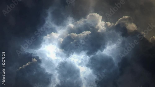 dark cumulonimbus clouds moving toward with thunderstorms within.