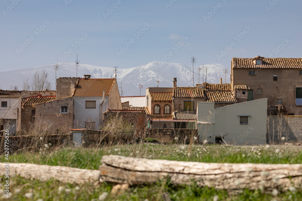 Charming photograph of the houses and rooftops in the small town of Bulbuente, in the Campo de Borja region, Zaragoza, Spain, with the Moncayo in the background, mountain of the Iberian System.