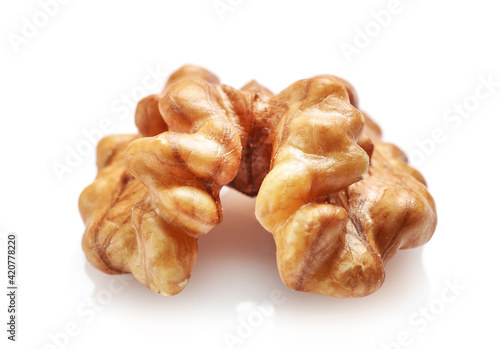 Single golden walnut kernel isolated on white
