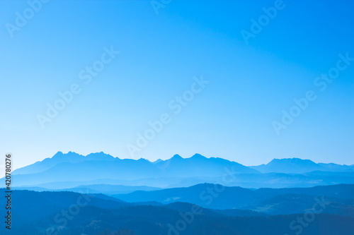 Blue surreal mountains against the backdrop of a cyan sky, fantastic fairytale mountain landscape © Bogdan