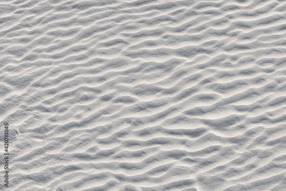 Abstract background. Diagonal sand stripes texture made by sea waves on beach. Abstract background. Diagonal sand stripes texture made by sea waves on beach.