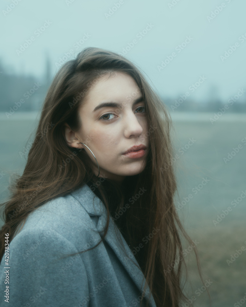 A girl walking in a foggy park A girl walking in a foggy park