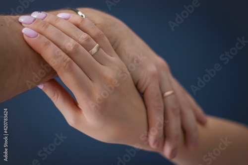 Wallpaper Mural A loving couple holding hands. Against a dark background. And wedding rings on my hands. Torontodigital.ca