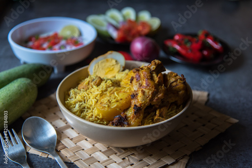 Close up of Mughal dish biryani with use of selective focus in a bowl on a background.