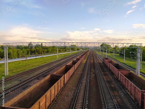 Aerial photo of railway terminal. Old freight wagons with goods on railroad station. Cargo transportation. Import and export logistics. Top view industrial landscape. Heavy industry.
