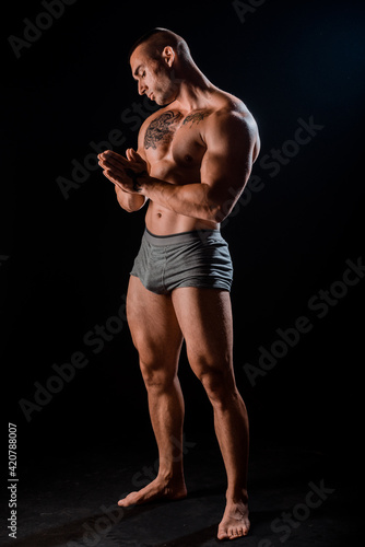 Bodybuilder showing his back and biceps muscles
