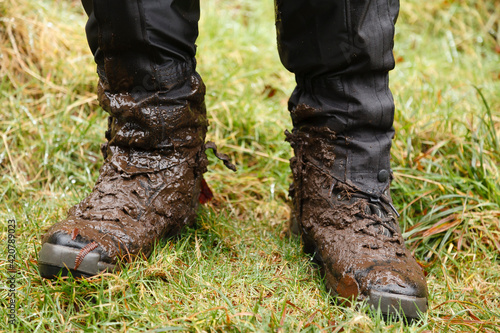 Muddy hiking boots and waterproof gaiters, UK photo