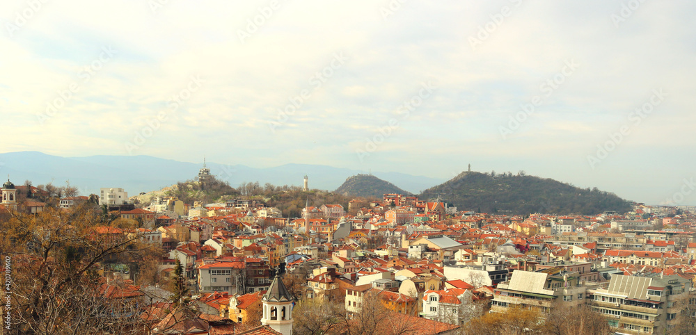 Panorama of Plovdiv, in Bulgaria with the roofs of the houses, the mountains in the background and a blue sky