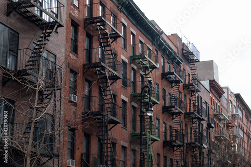 Row of Old Brick Buildings on the Lower East Side of New York City with Fire Escapes