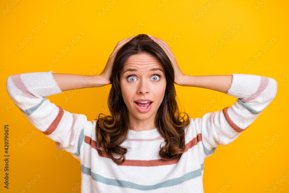 Portrait of impressed person arms on head open mouth look camera cant believe isolated on yellow color background Portrait of impressed person arms on head open mouth look camera cant believe isolated on yellow color background