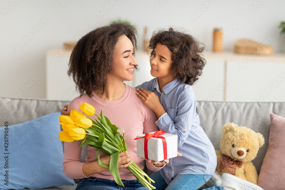 Black girl celebrating mother's day, greeting her mom Black girl celebrating mother's day, greeting her mom