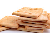 A stack of square crisp crackers on a white background.