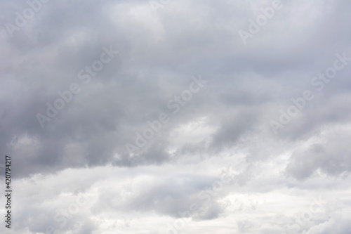 Grey sky with fluffy clouds, abstract background