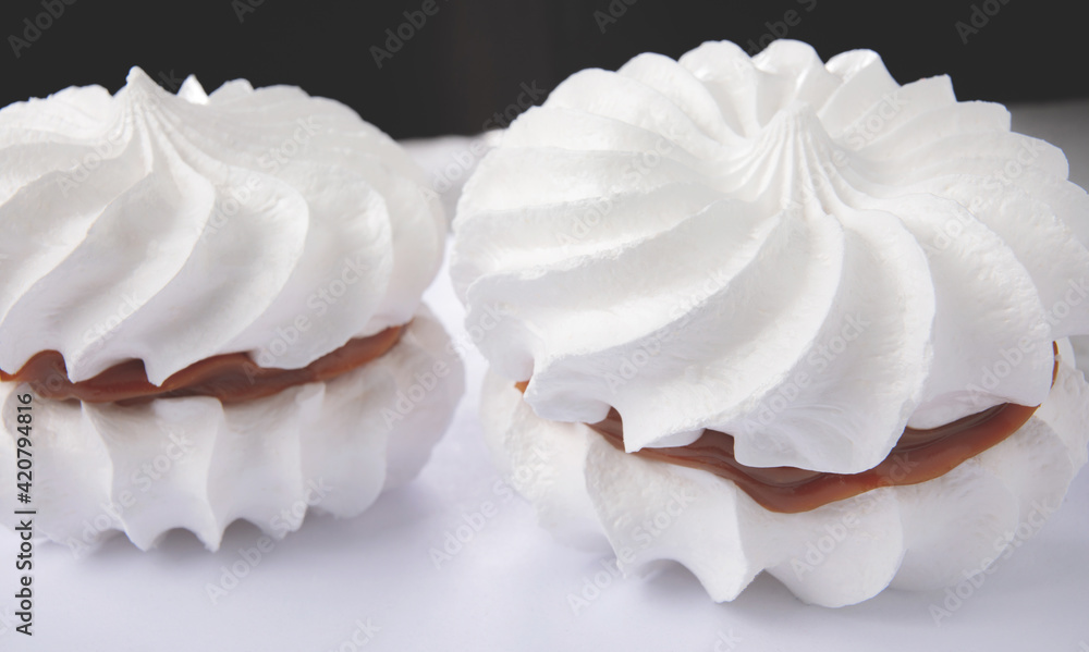 Two snow-white meringues. Beautiful white cake. Two snow-white meringues. Beautiful white cake.