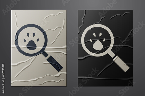 White Paw search icon isolated on crumpled paper background. Magnifying glass with animal footprints. Paper art style. Vector