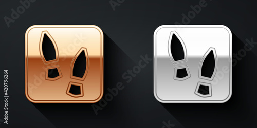 Gold and silver Human footprints shoes icon isolated on black background. Shoes sole. Long shadow style. Vector